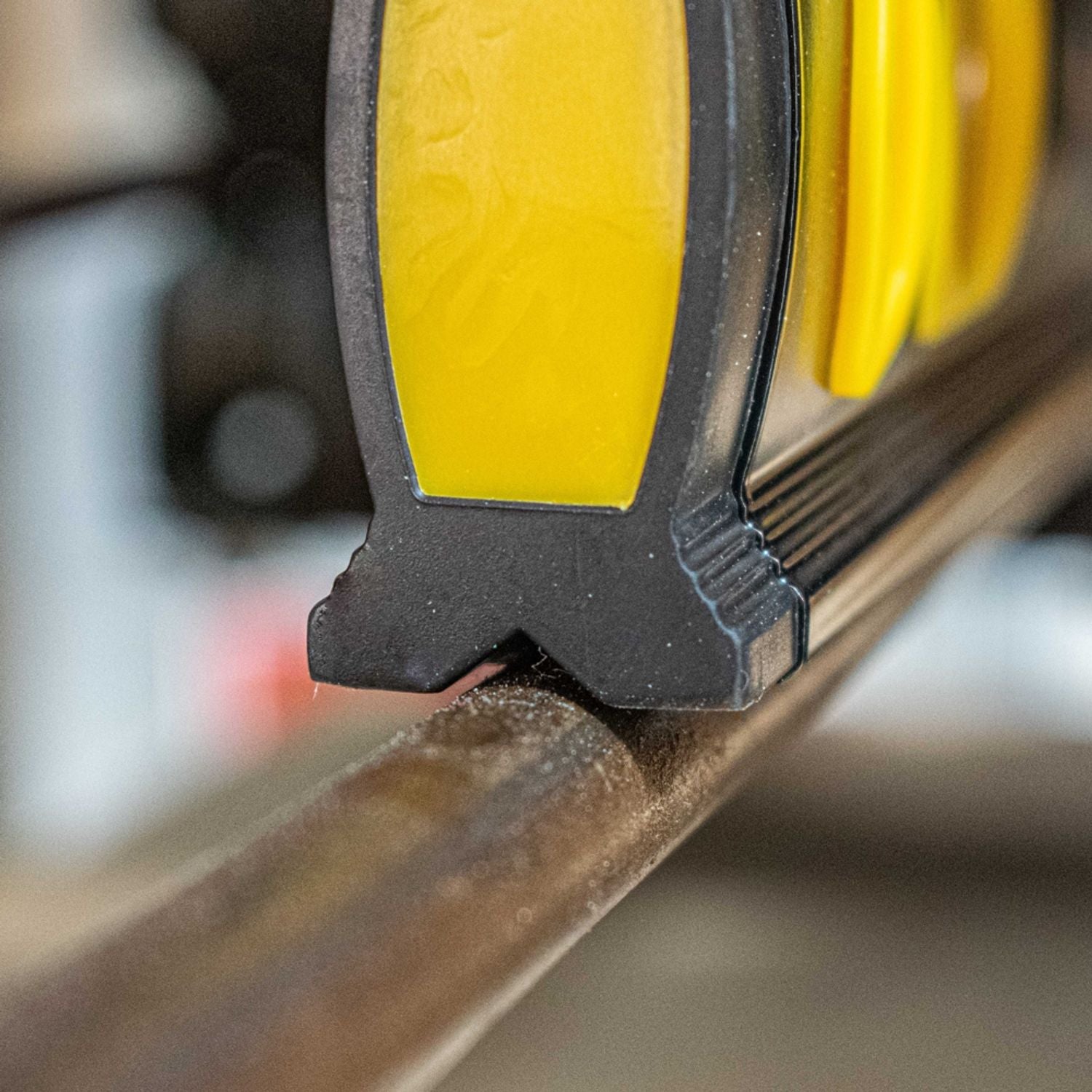 Close-up of spirit level end with yellow vial window and textured black frame