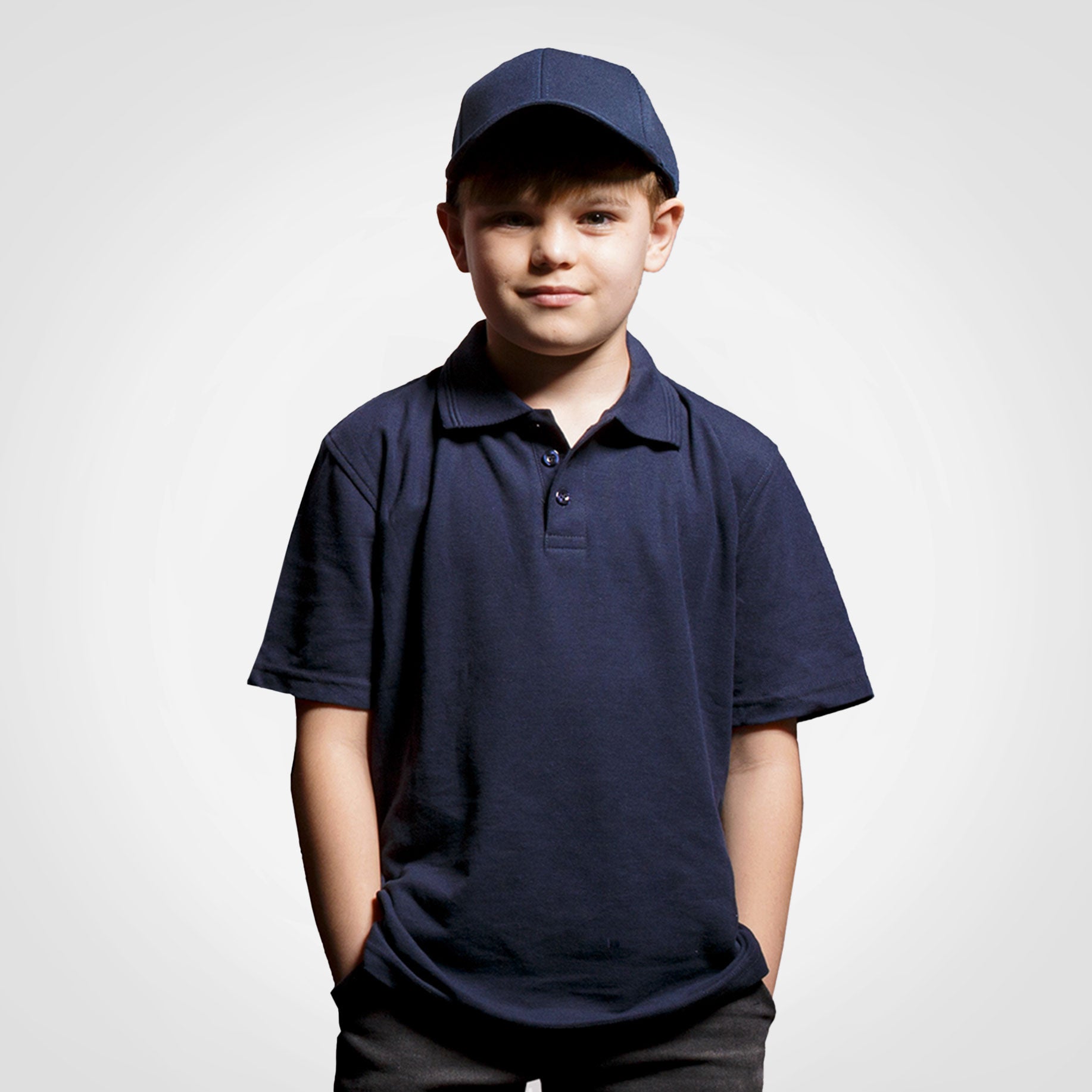 Kids navy polo golf shirt with short sleeves, button placket, and collar
