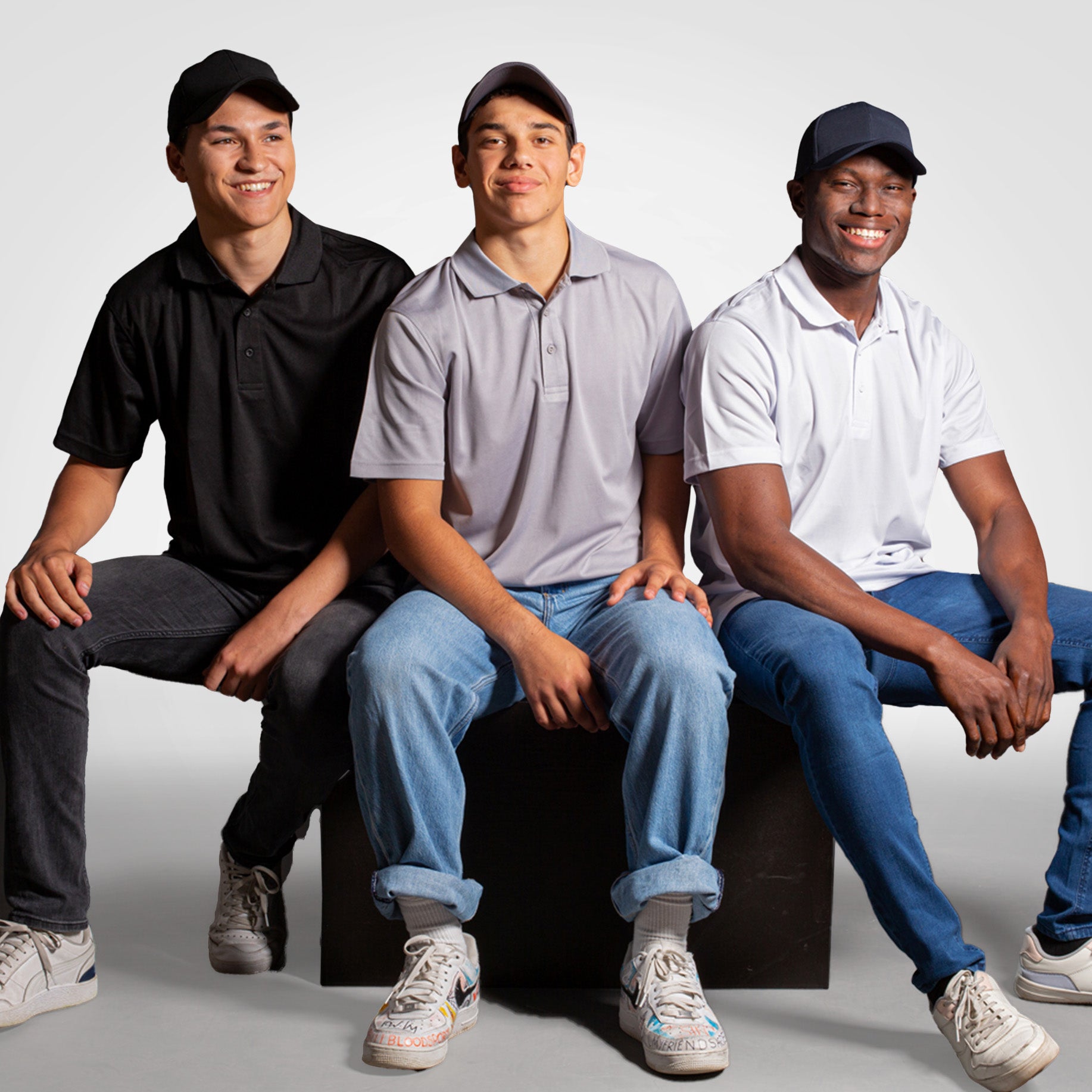 Men's golf polo shirts in black, light gray, and white on models