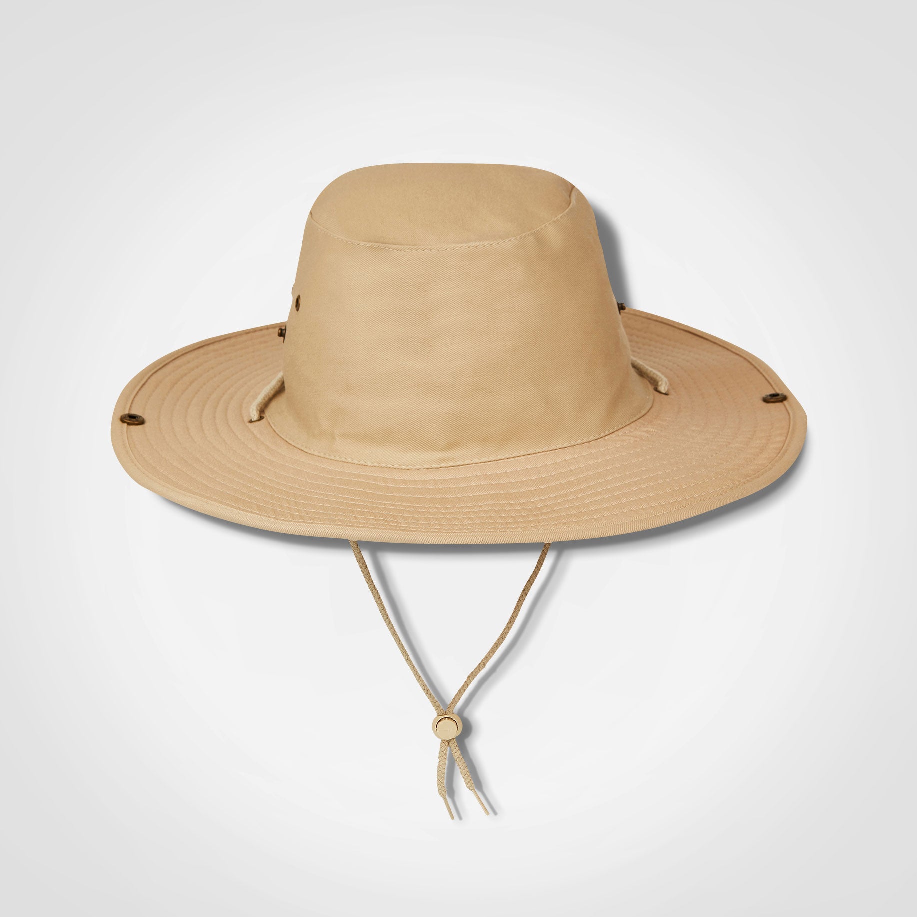 Beige bush hat with wide brim and chin strap ties